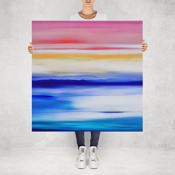 Santorini – limited edition abstract art print by INKIS, shown unframed and held for scale in 100 × 100 cm size, featuring vibrant pinks, blues, and yellow colour gradients, available at Tonomi